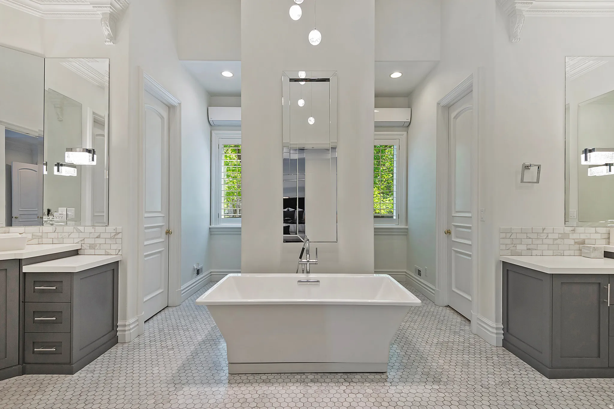 Huge primary suite bath featuring dual vanities, dual water closets and walk-in closets, spa inspired shower and soaker tub.