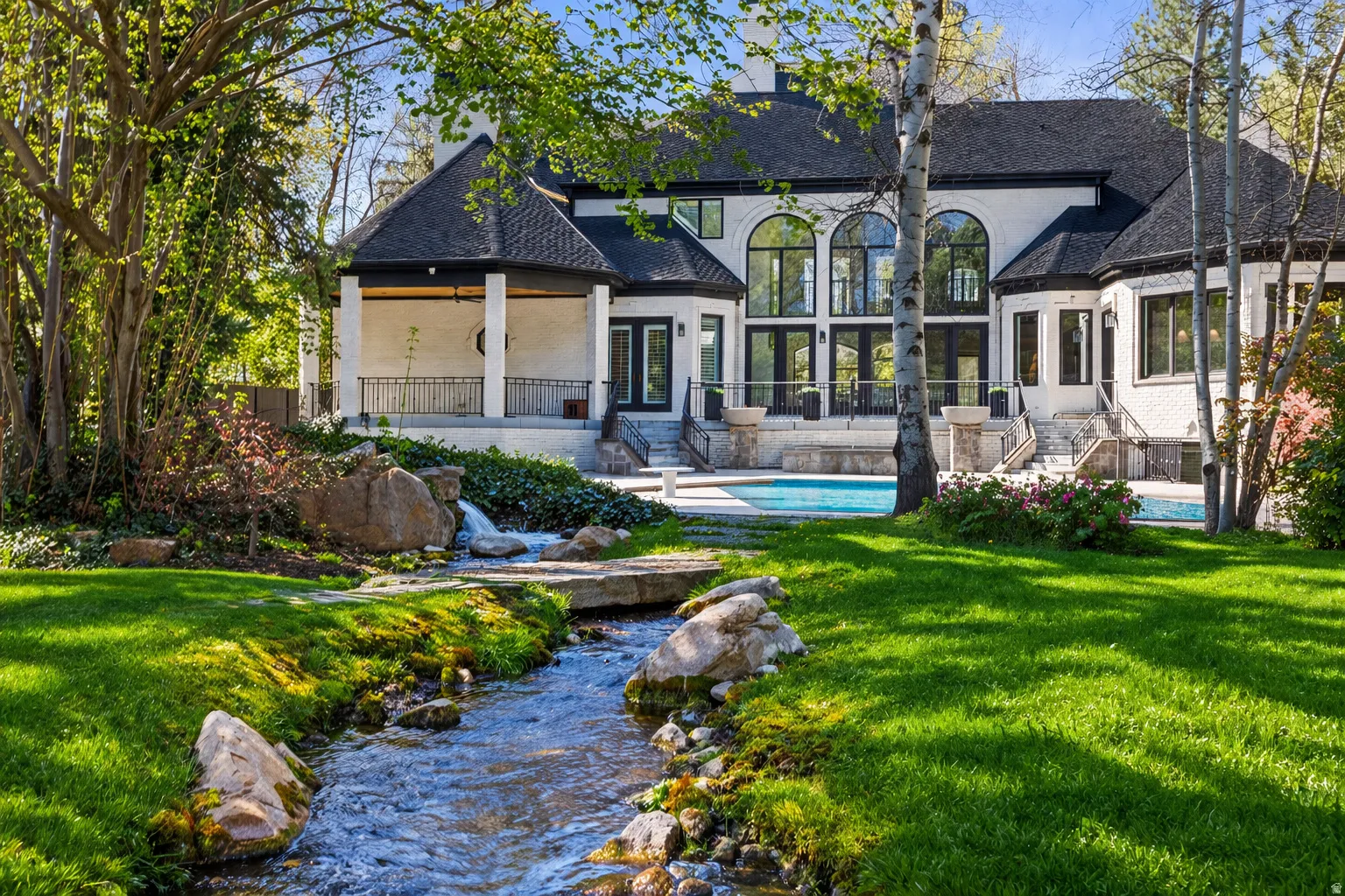 A private and secluded backyard to die for!  Streams, ponds, saline swimming pool, spa, basketball court, lighted outdoor kitchen, fire bowls and more.