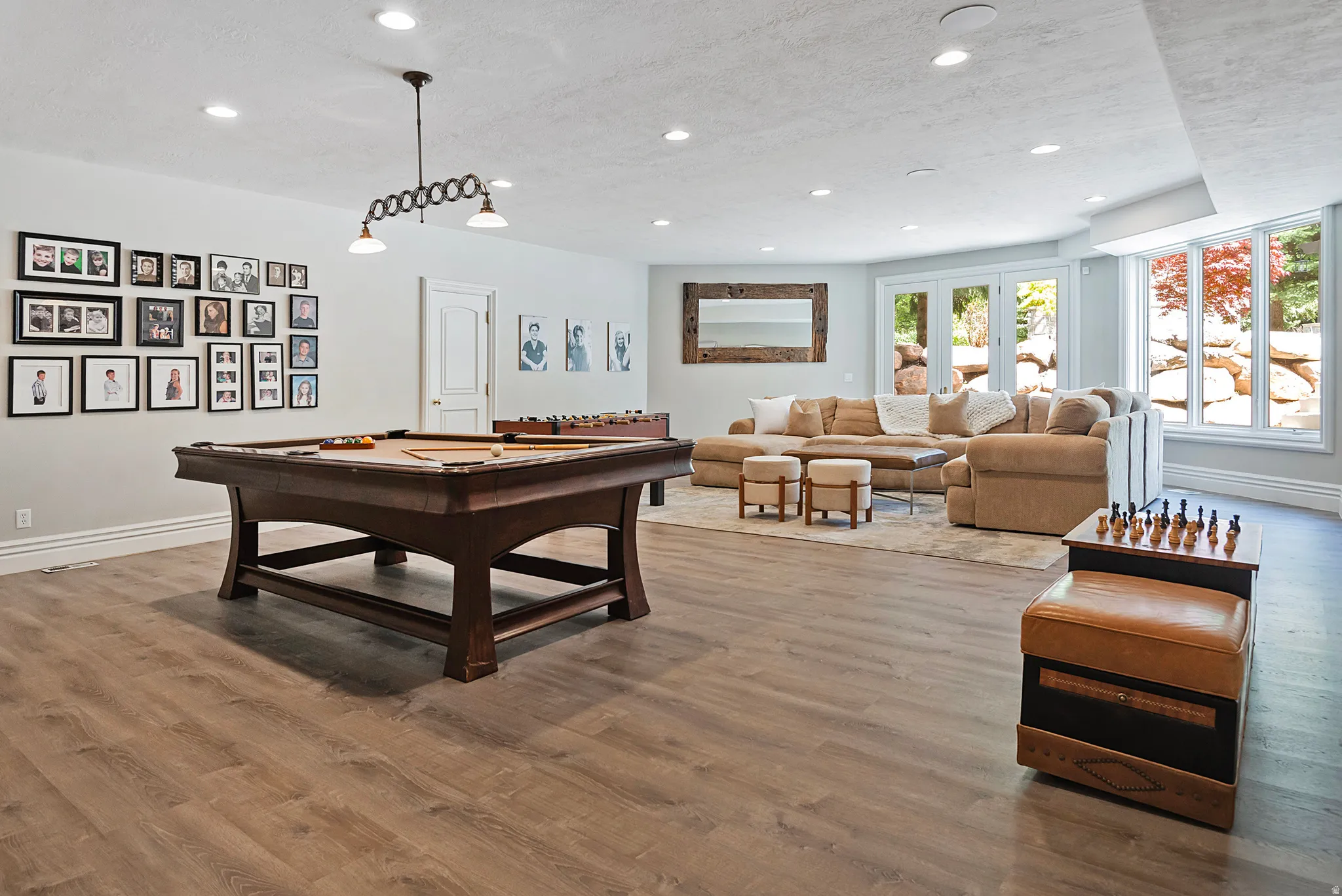 Recreation room featuring light wood finished floors, recessed lighting, and pool table - walkout to pool and backyard