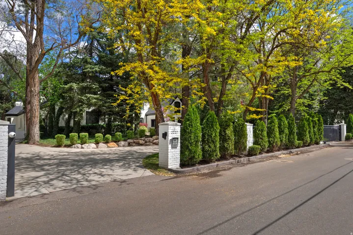 View of front facade, gates and treelined street