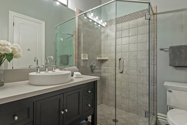Bathroom featuring vanity and a stall shower