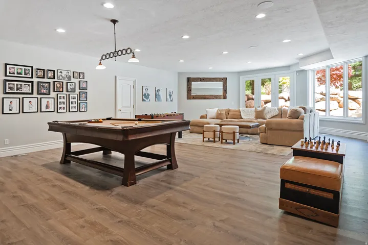 Recreation room featuring light wood finished floors, recessed lighting, and pool table - walkout to pool and backyard