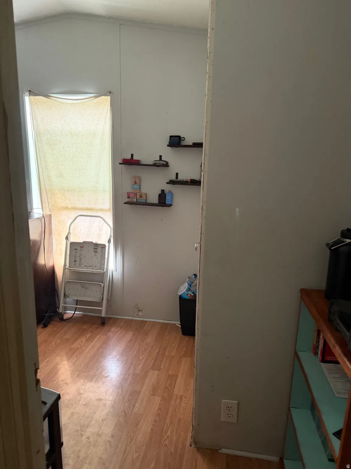 Bedroom featuring light wood-style floors and vaulted ceiling
