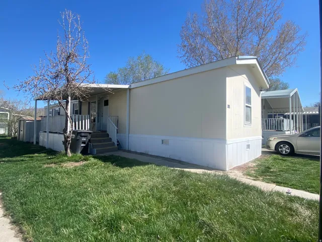 View of side of home featuring crawl space and a yard