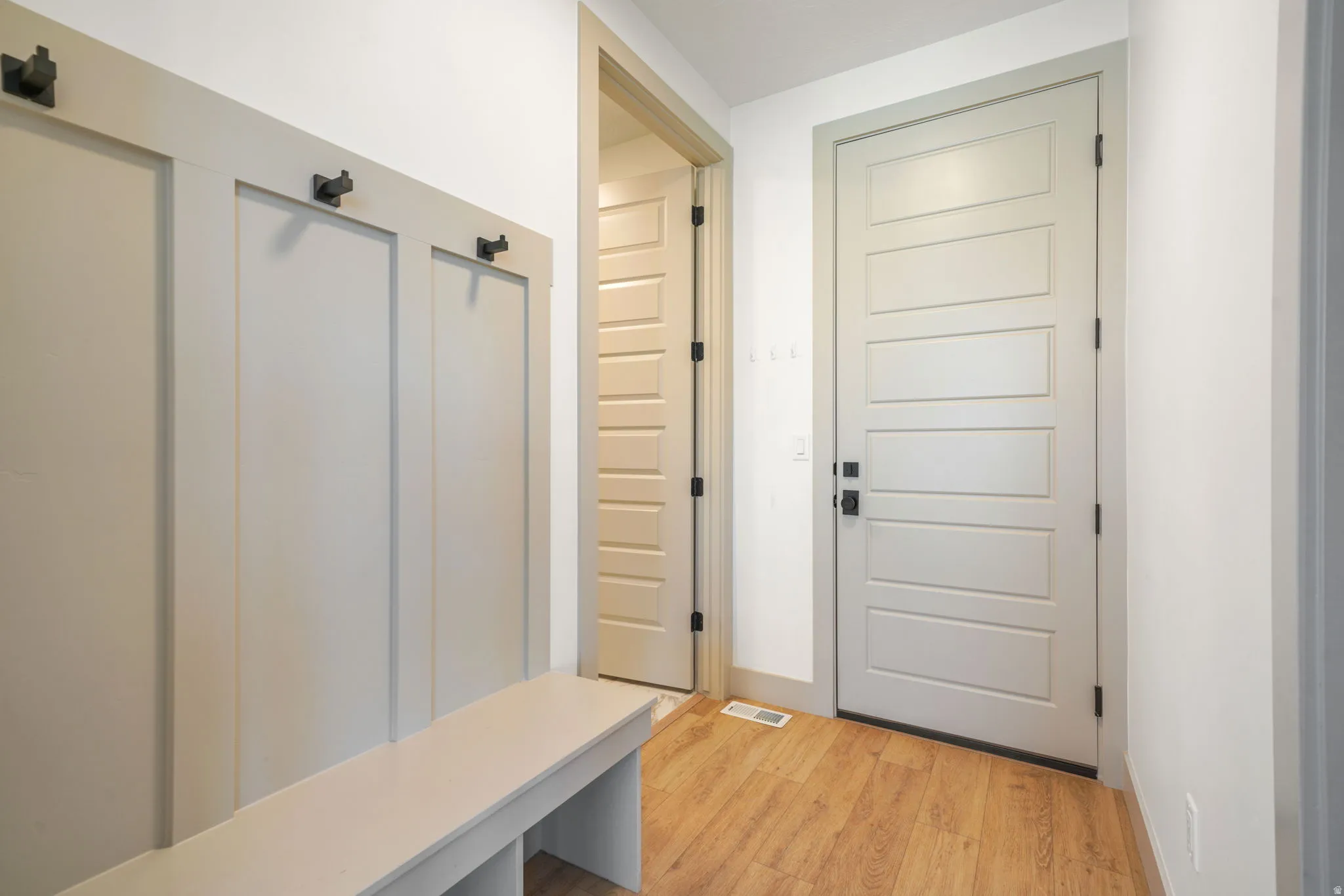 Mudroom featuring light wood-style flooring