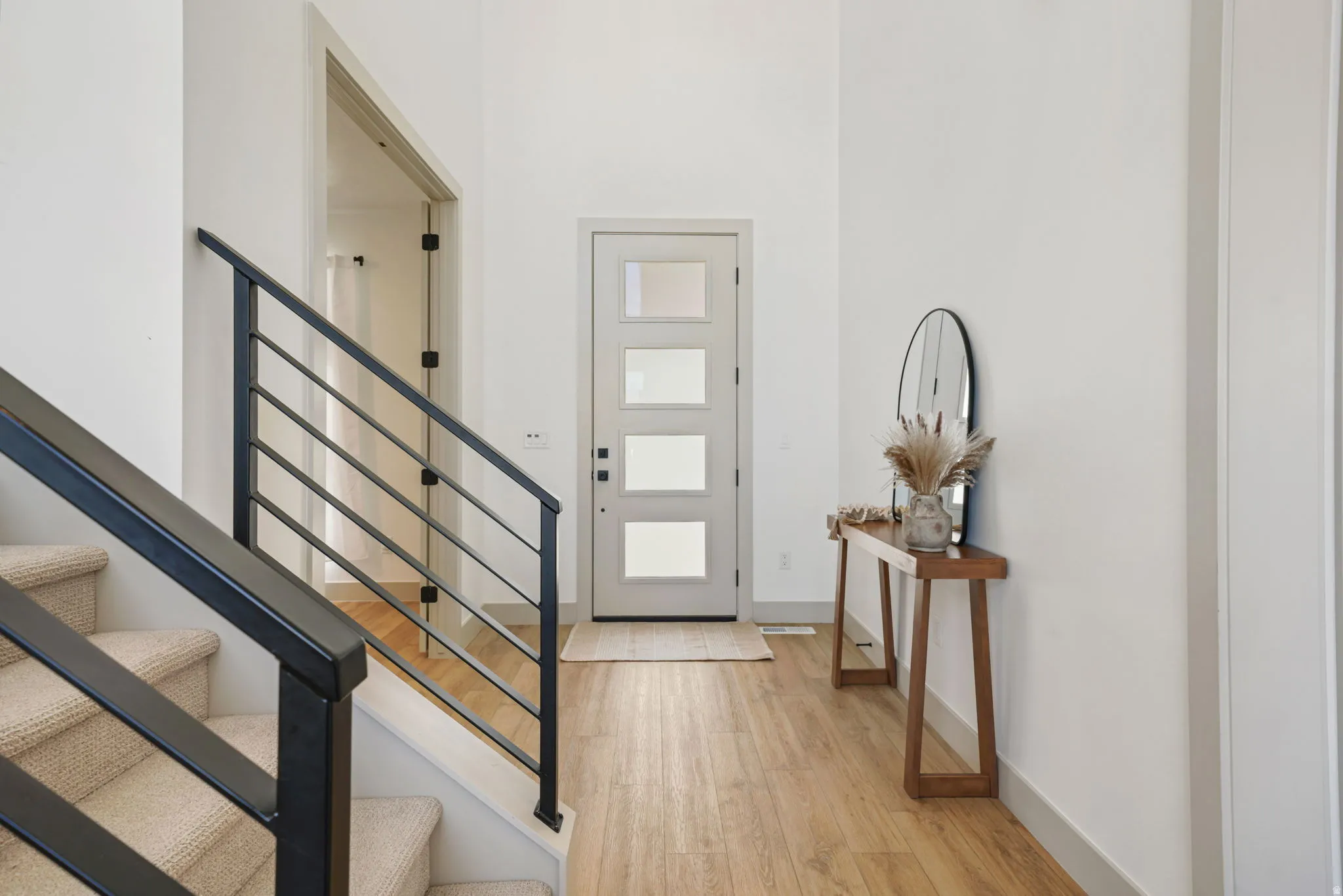 Foyer entrance featuring stairway and light wood-type flooring
