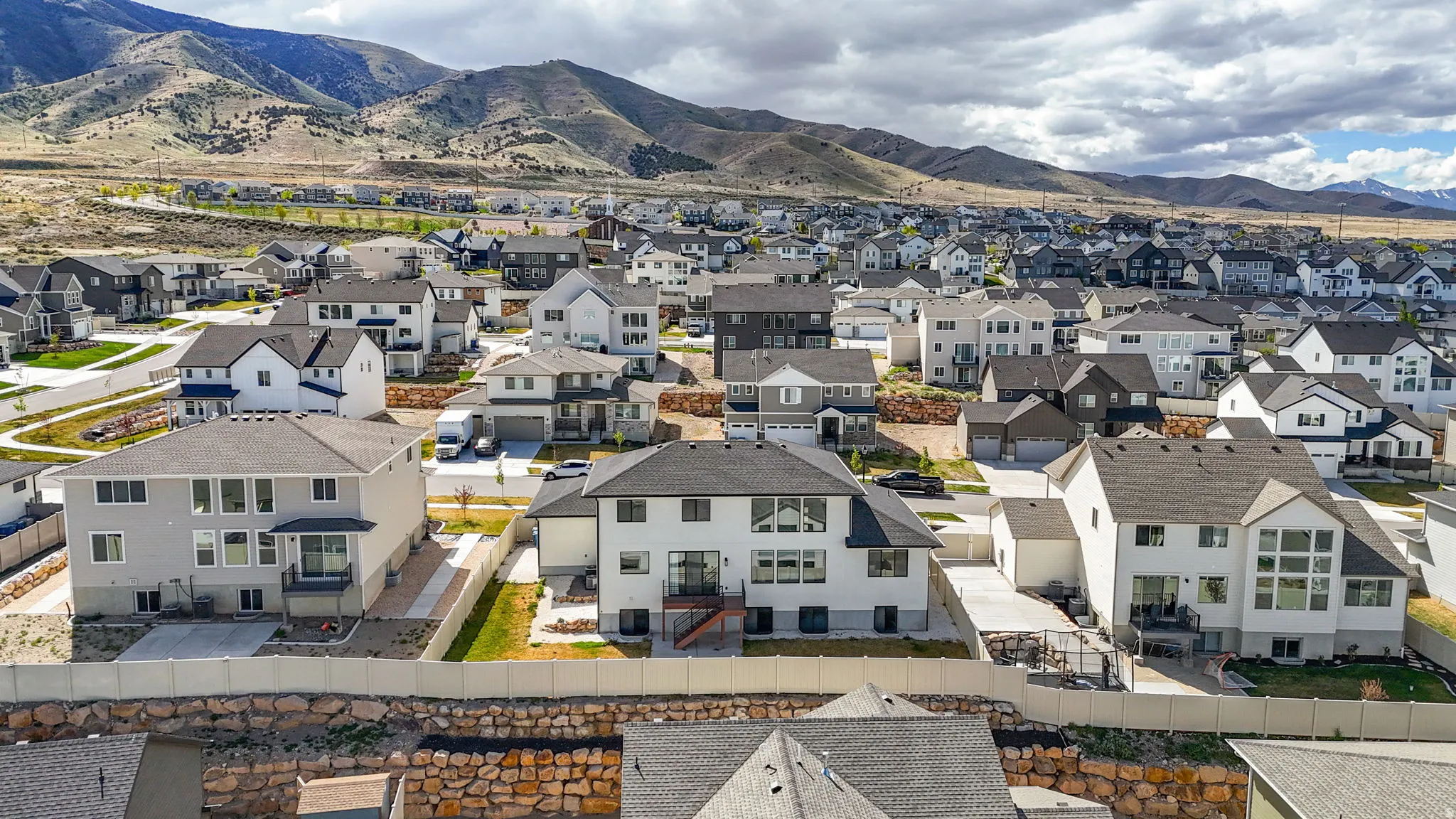 Aerial perspective of suburban area with a mountain backdrop