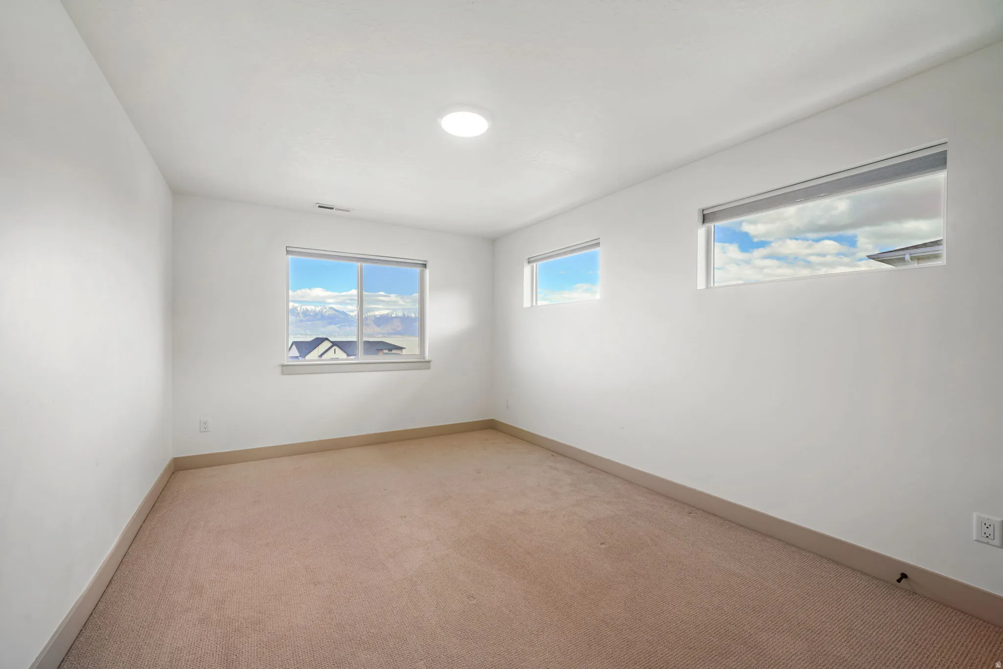 Spare room with baseboards and carpet