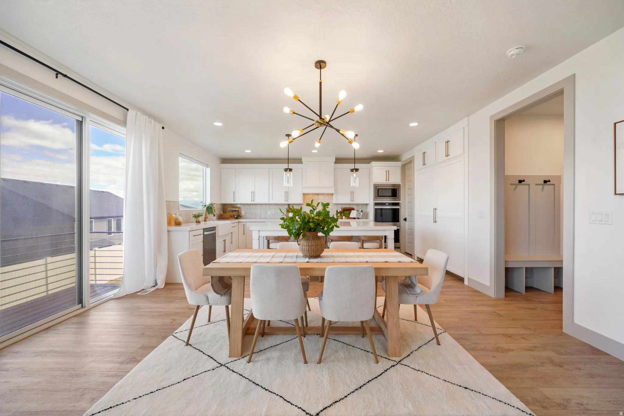Dining room featuring light wood-style floors and suspended lighting
