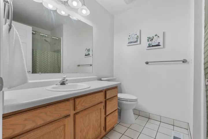 Bathroom with vanity, a shower stall, and light tile patterned floors