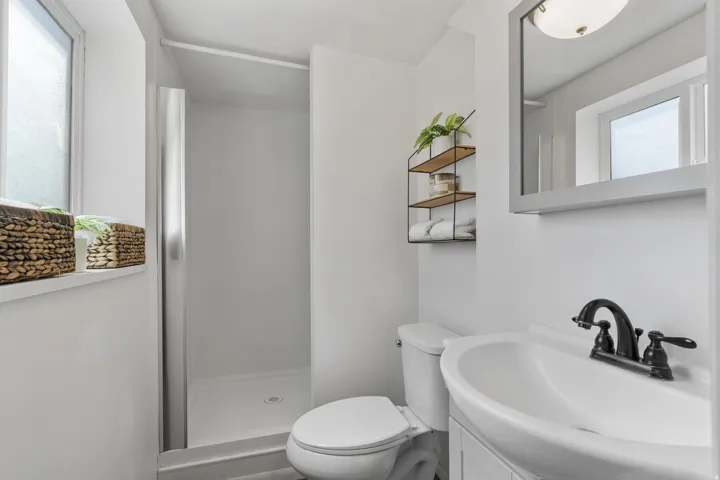 Full bath featuring vanity and a stall shower