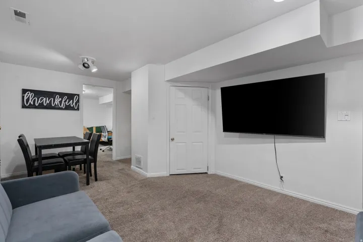 Carpeted living room featuring baseboards