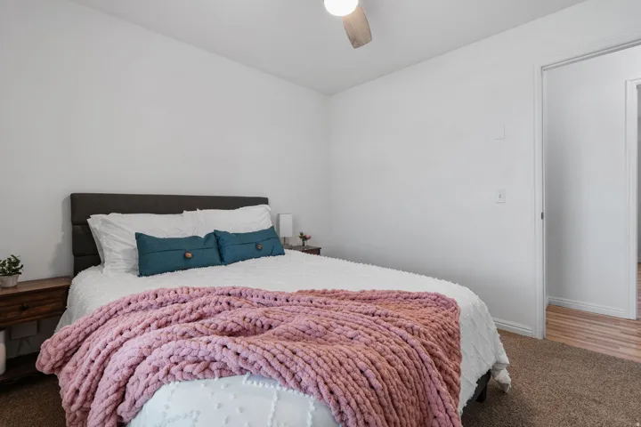 Bedroom featuring light carpet and a ceiling fan