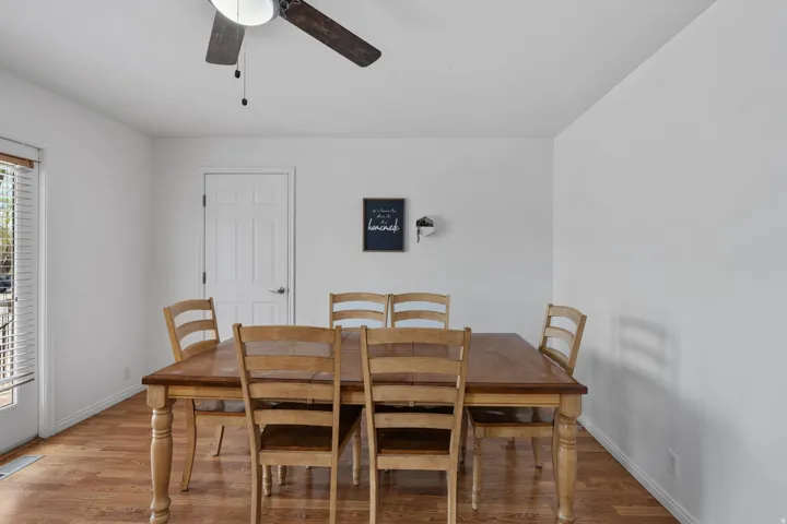 Dining room with wood finished floors and a ceiling fan