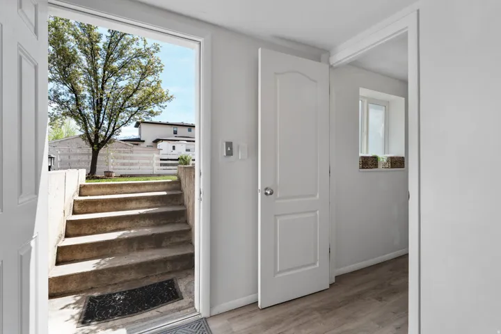 Stairway with wood finished floors and baseboards