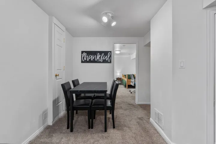 Dining space featuring light carpet and baseboards