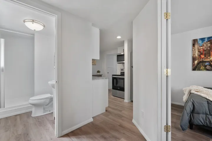 Corridor featuring light wood finished floors and recessed lighting