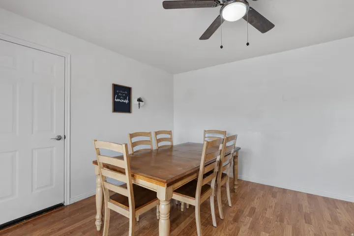 Dining area featuring a ceiling fan and wood finished floors