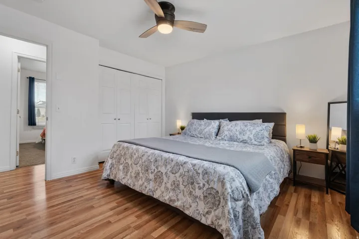 Bedroom with light wood-style flooring, a closet, and ceiling fan