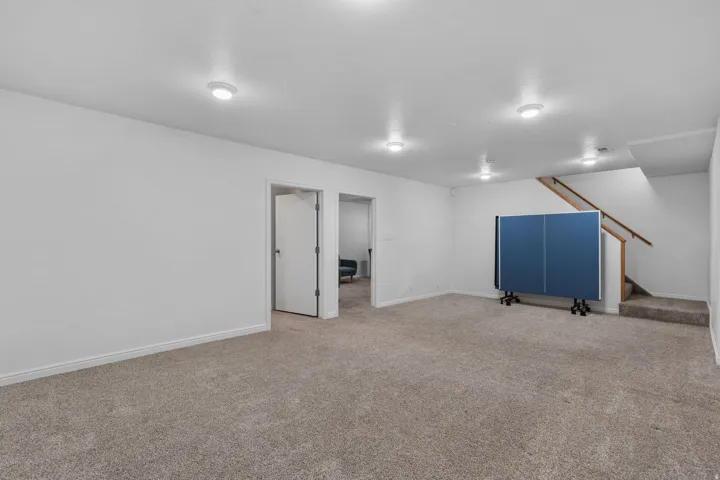 Finished basement with stairs and carpet floors