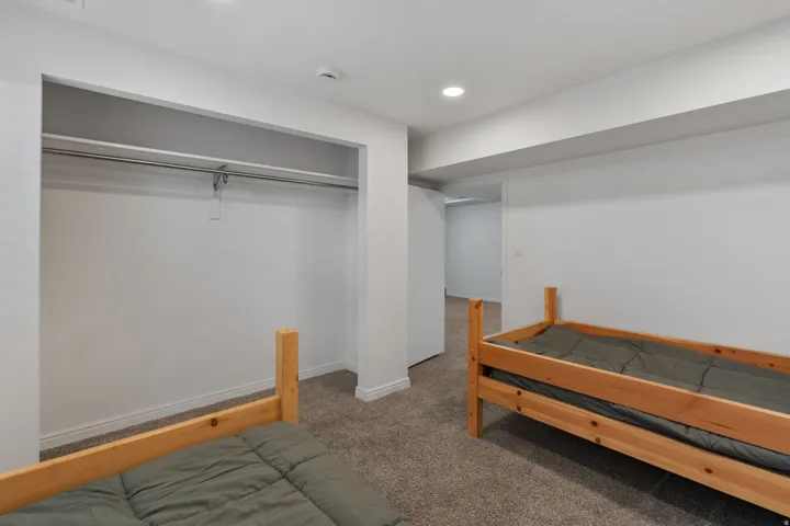 Carpeted bedroom featuring recessed lighting and a closet