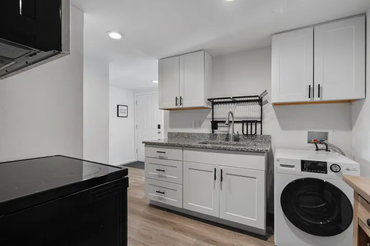 Laundry area with washer / clothes dryer, light wood-style flooring, and recessed lighting