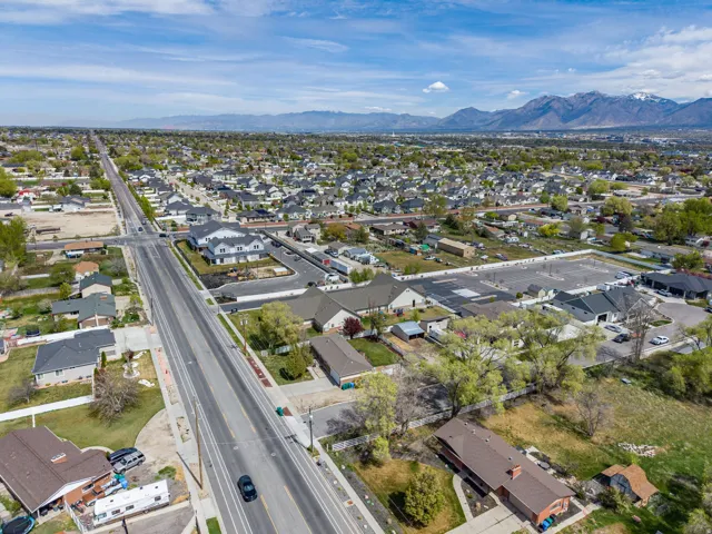 Aerial view of property's location with nearby suburban area and a mountain backdrop
