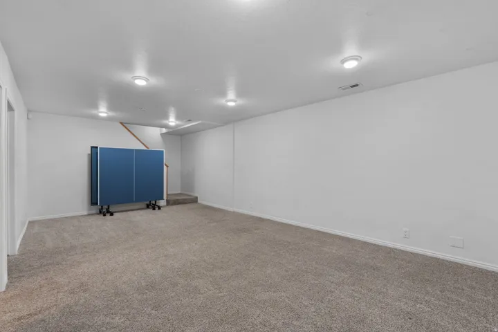 Finished basement featuring carpet and baseboards