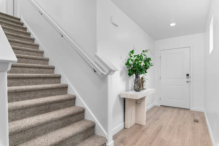 Foyer entrance with stairway and light wood-type flooring