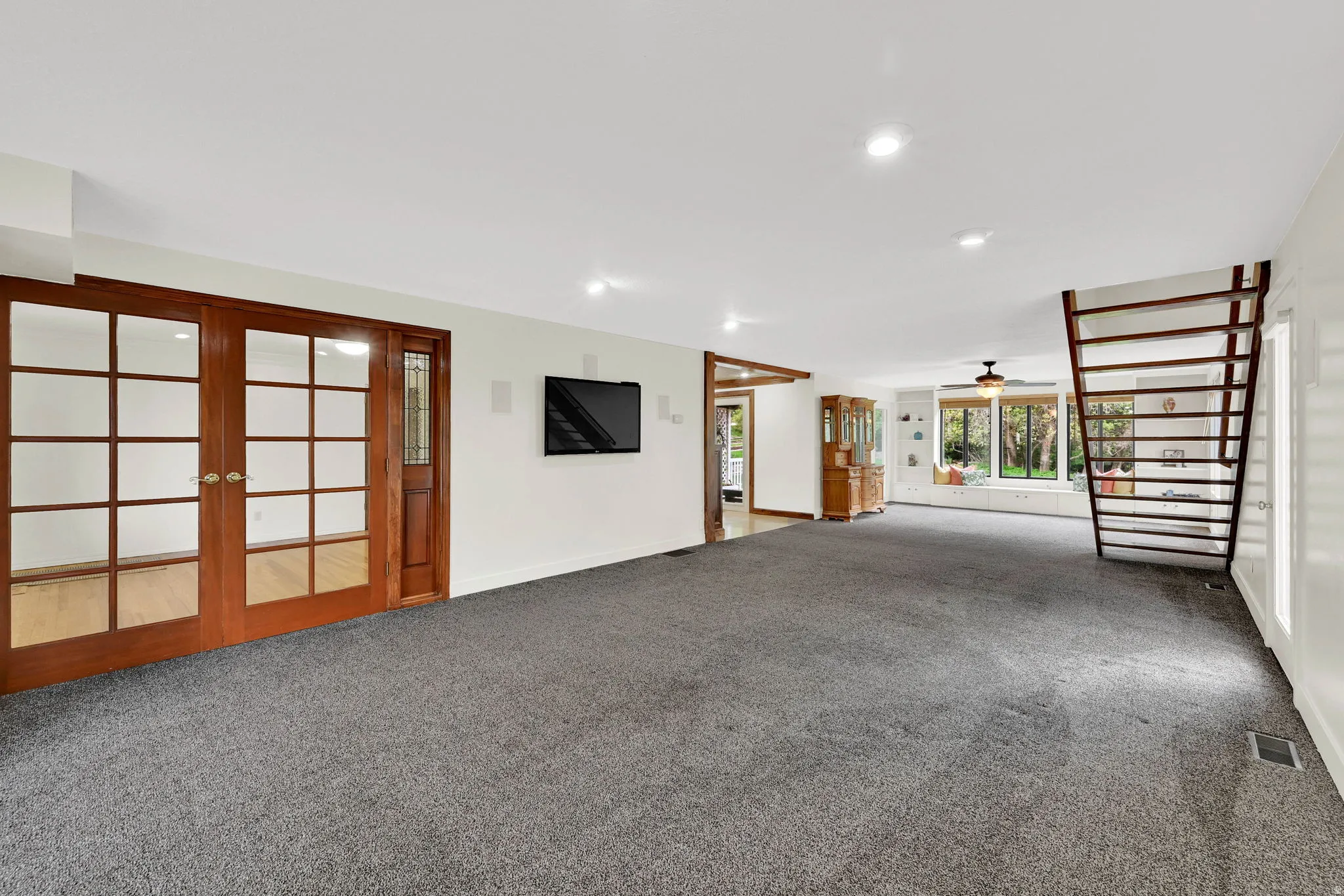 Unfurnished living room with carpet flooring, french doors, a ceiling fan, and recessed lighting