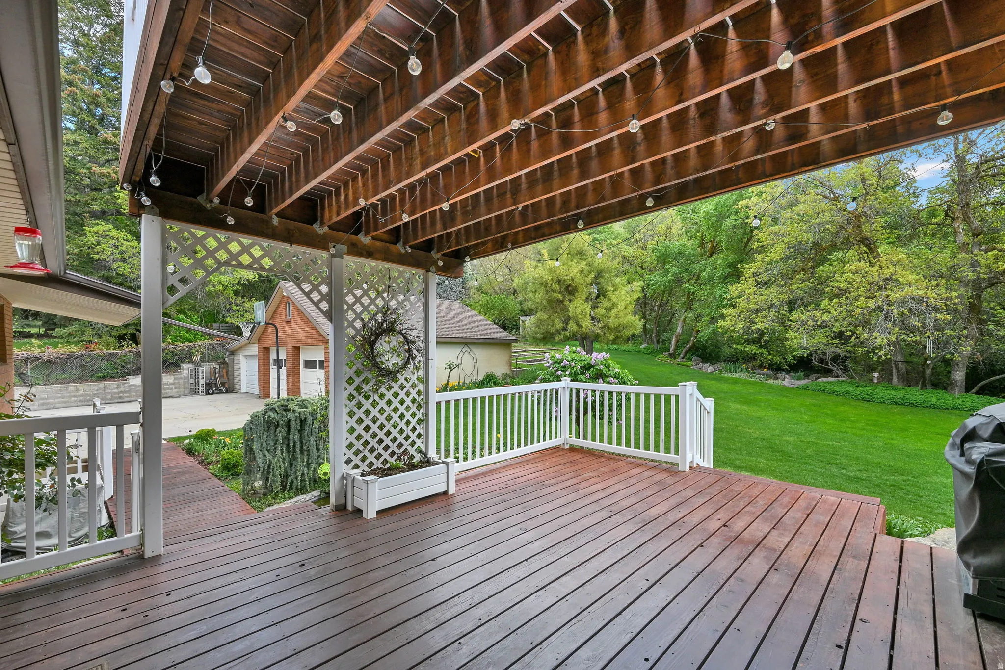 Deck featuring an outdoor structure, a yard, and area for grilling