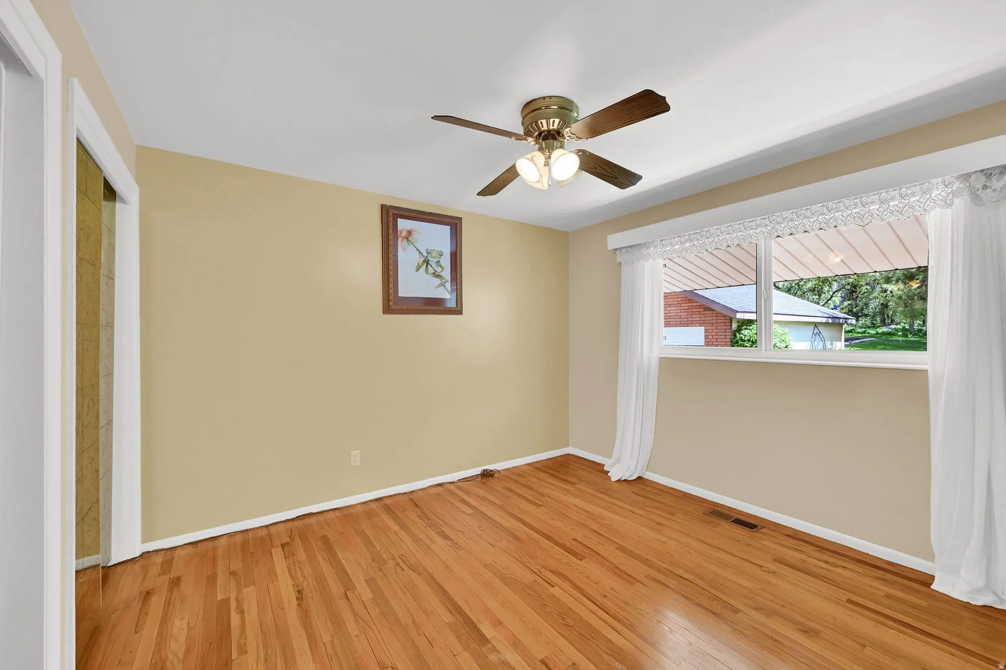 Unfurnished bedroom with light wood-style flooring, ceiling fan, and a closet