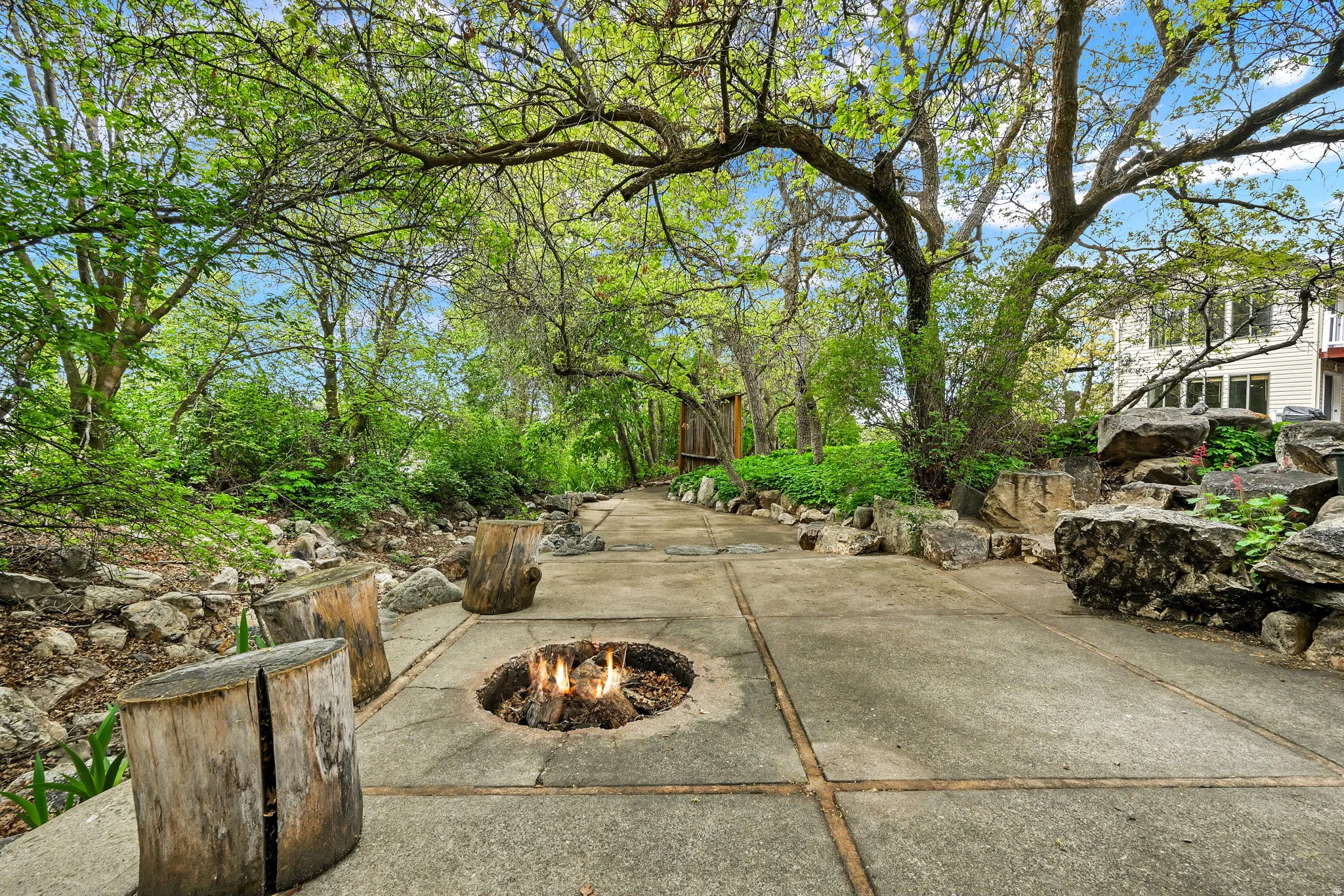Downstream view of backyard patio / terrace with an outdoor fire pit