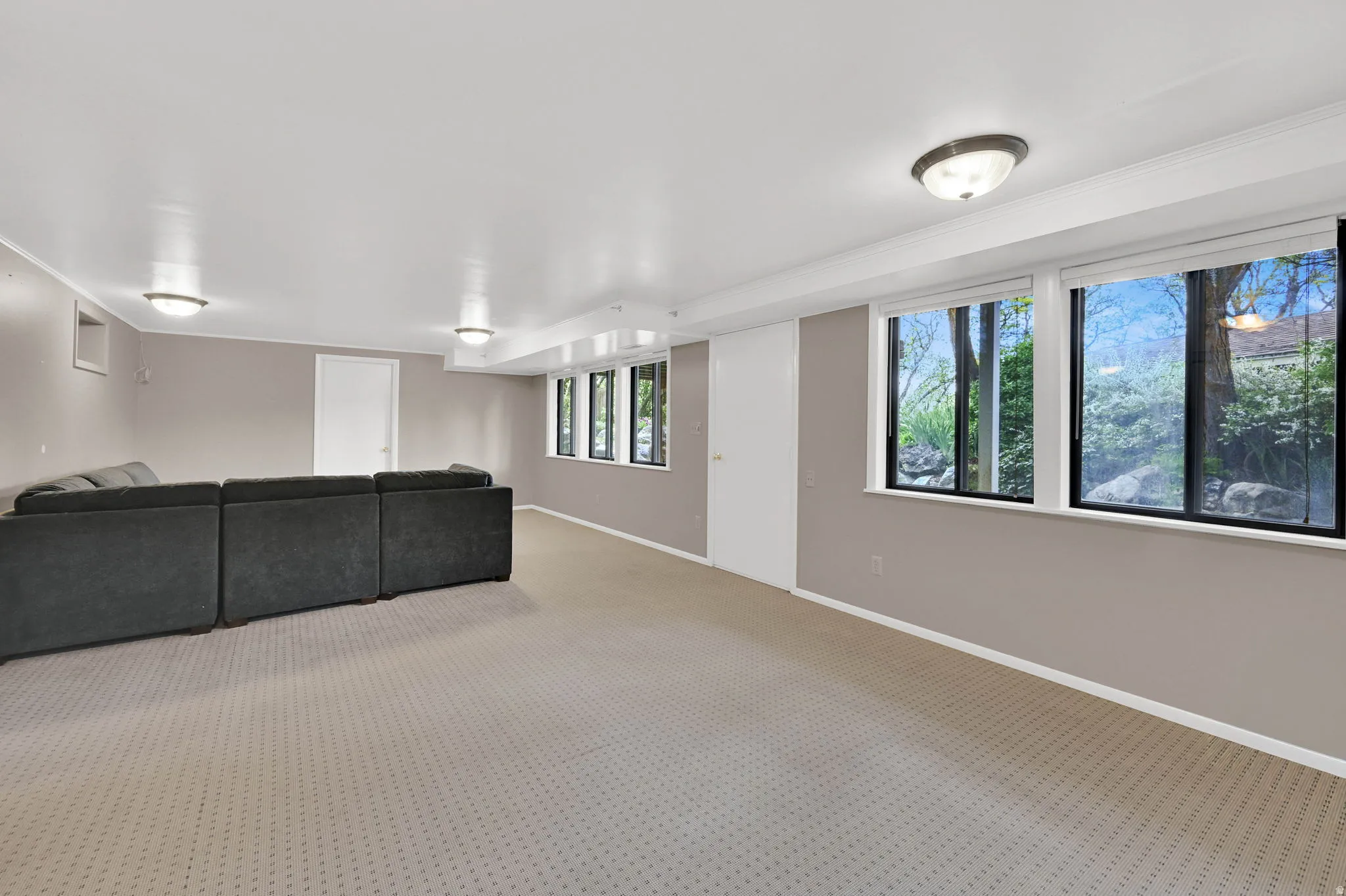Basement with baseboards and carpet flooring