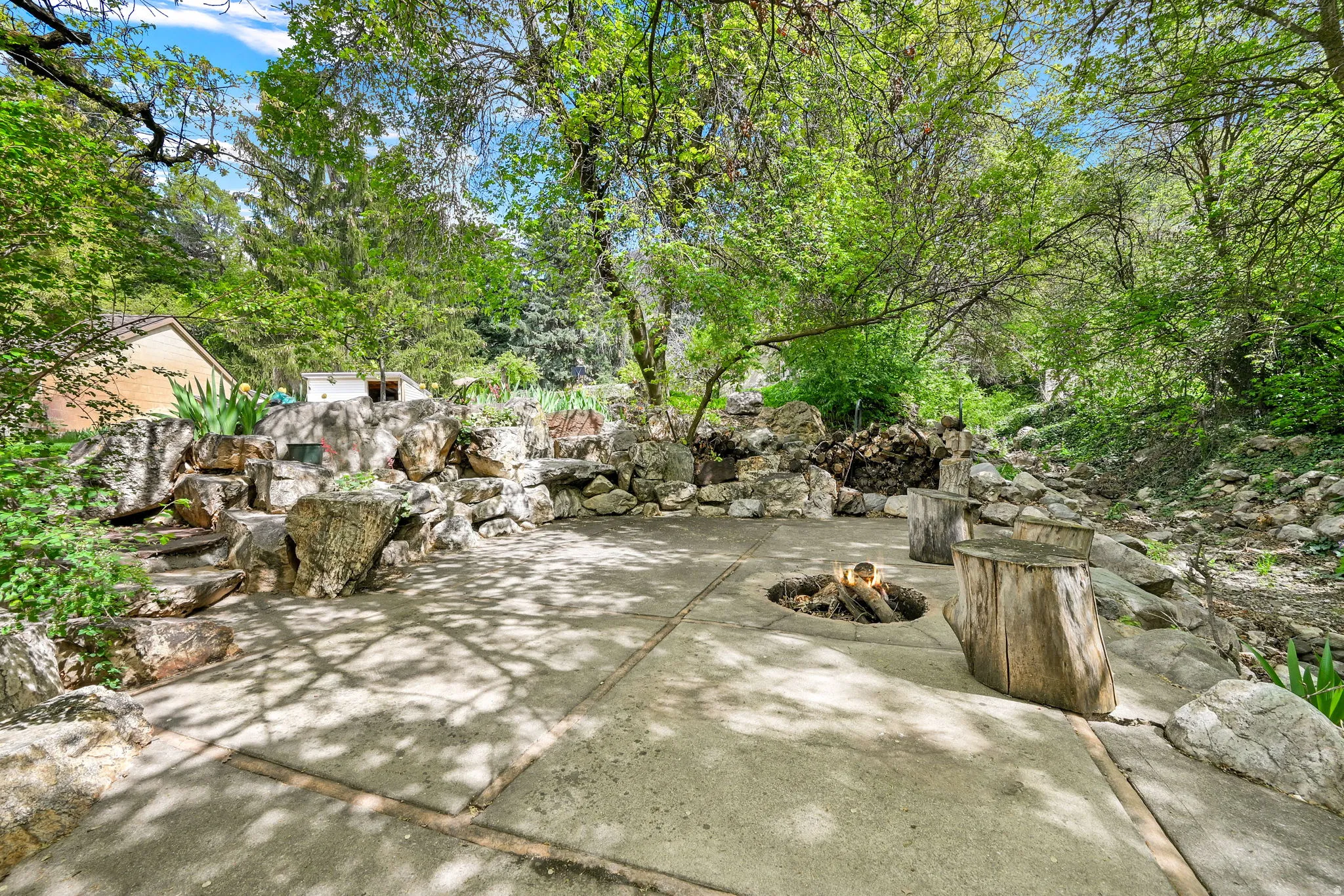 View of patio / terrace featuring view of stream and firepit