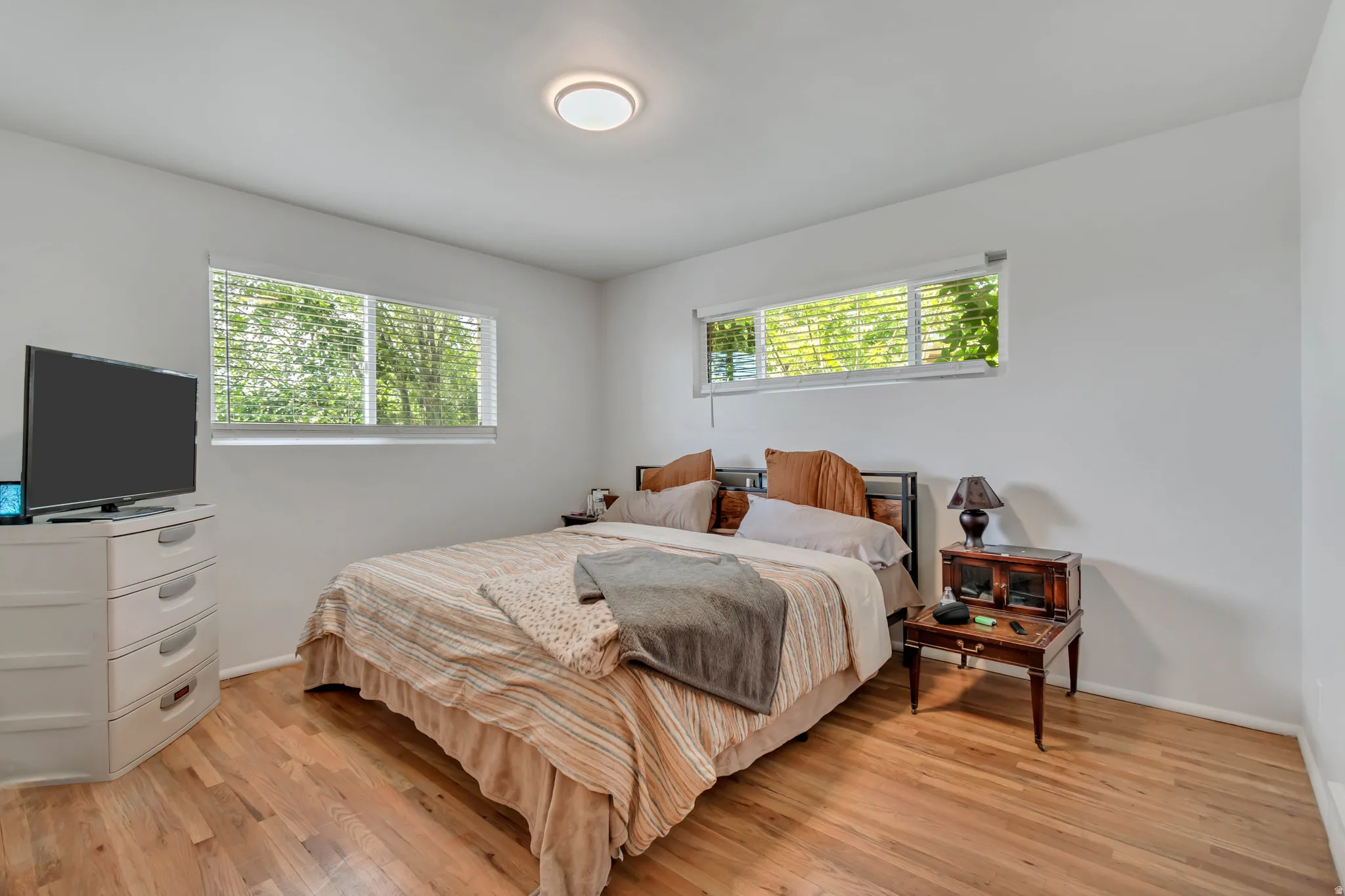 Bedroom with light wood-style floors and baseboards