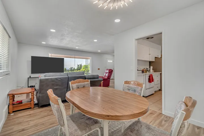 Dining space with light wood-style flooring and recessed lighting