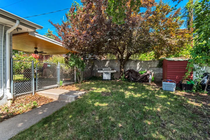 Fenced backyard featuring a gate