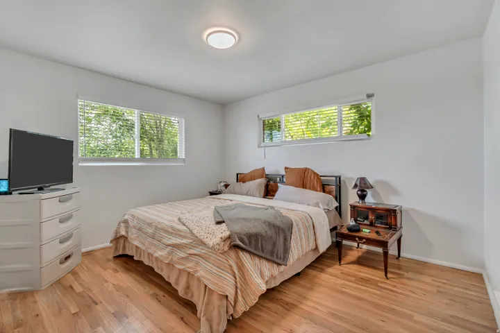 Bedroom with light wood-style floors and baseboards
