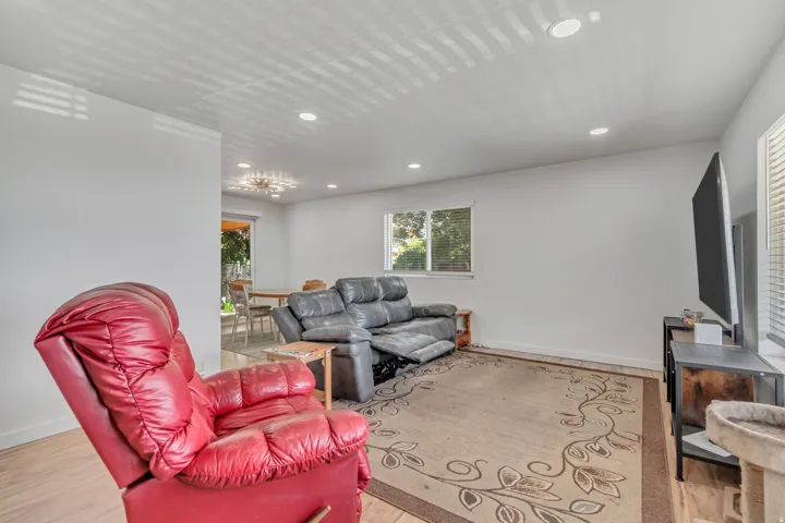 Living room with recessed lighting and light wood-style floors