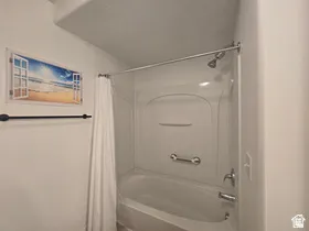 Bathroom featuring shower / bath combo with shower curtain