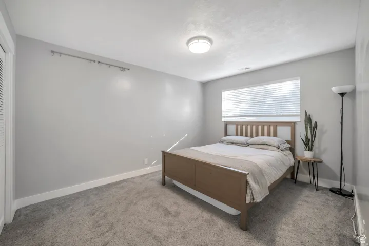 Bedroom with carpet floors and baseboards