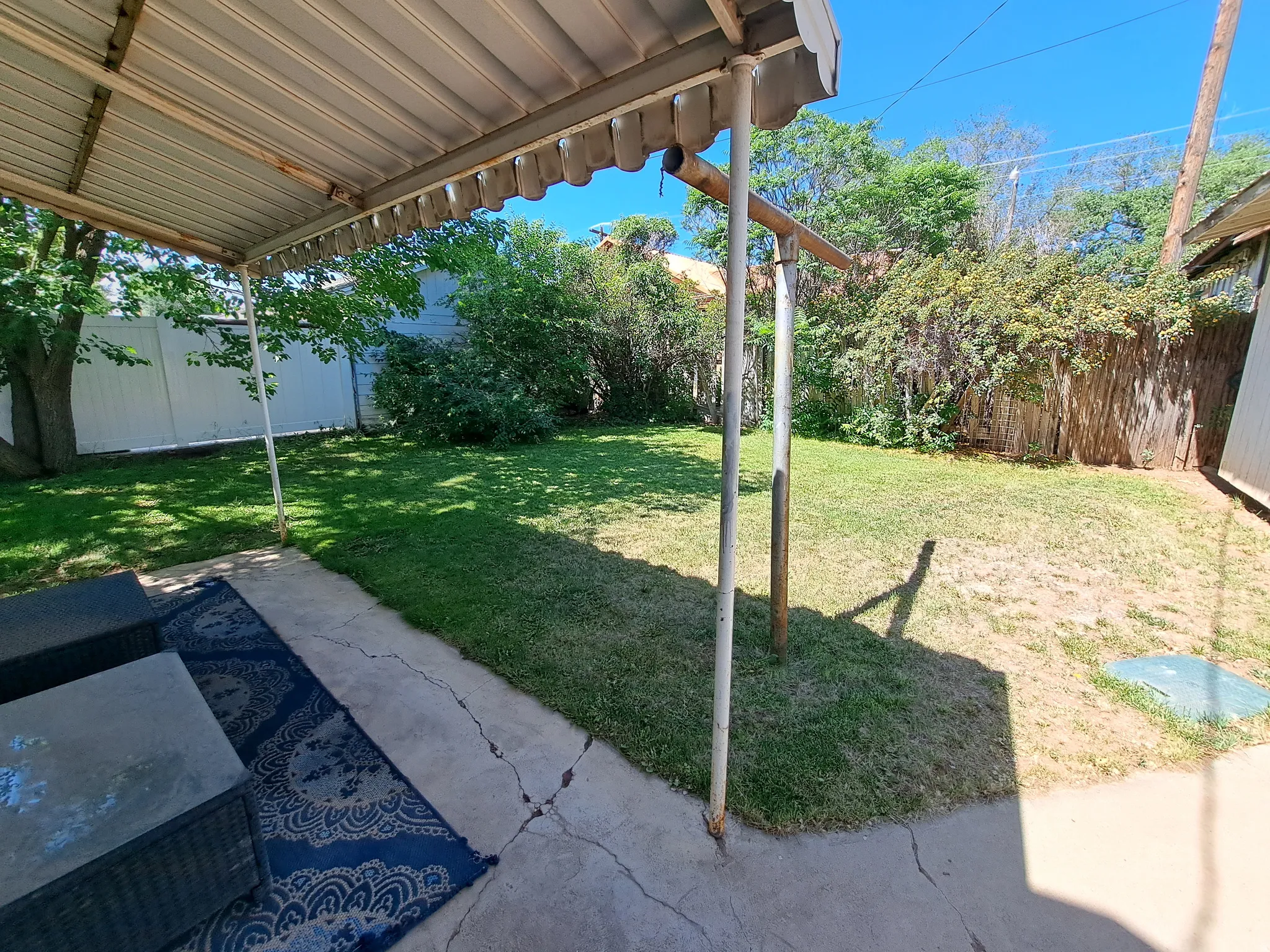Fenced backyard featuring a patio