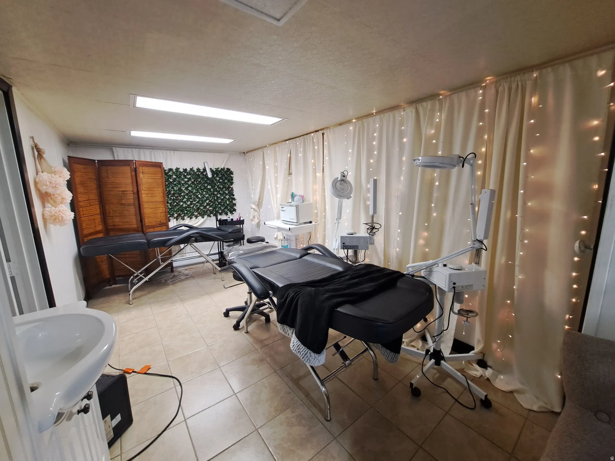 Room featuring light tile patterned floors and a textured ceiling