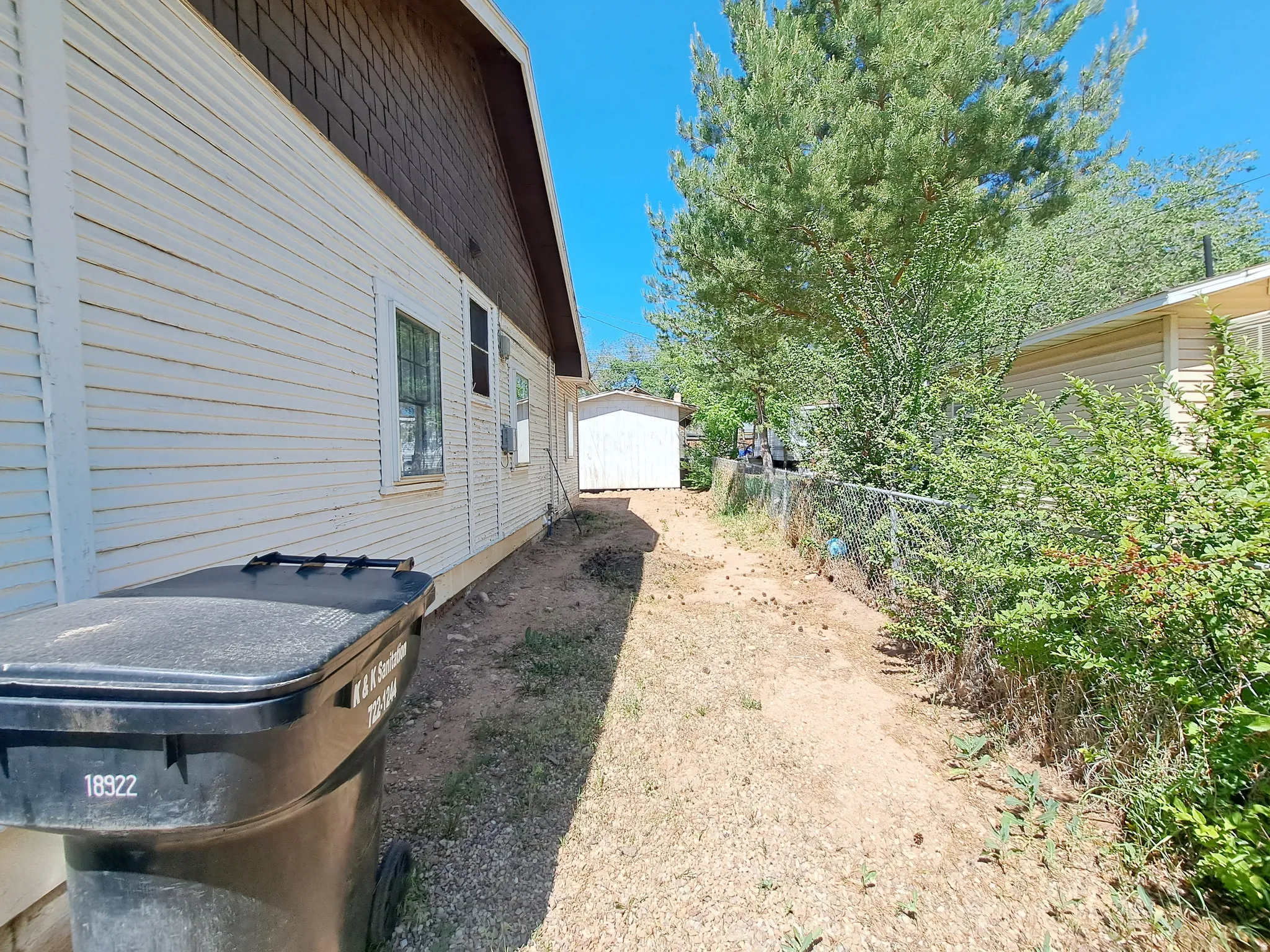 View of more parking with a storage shed