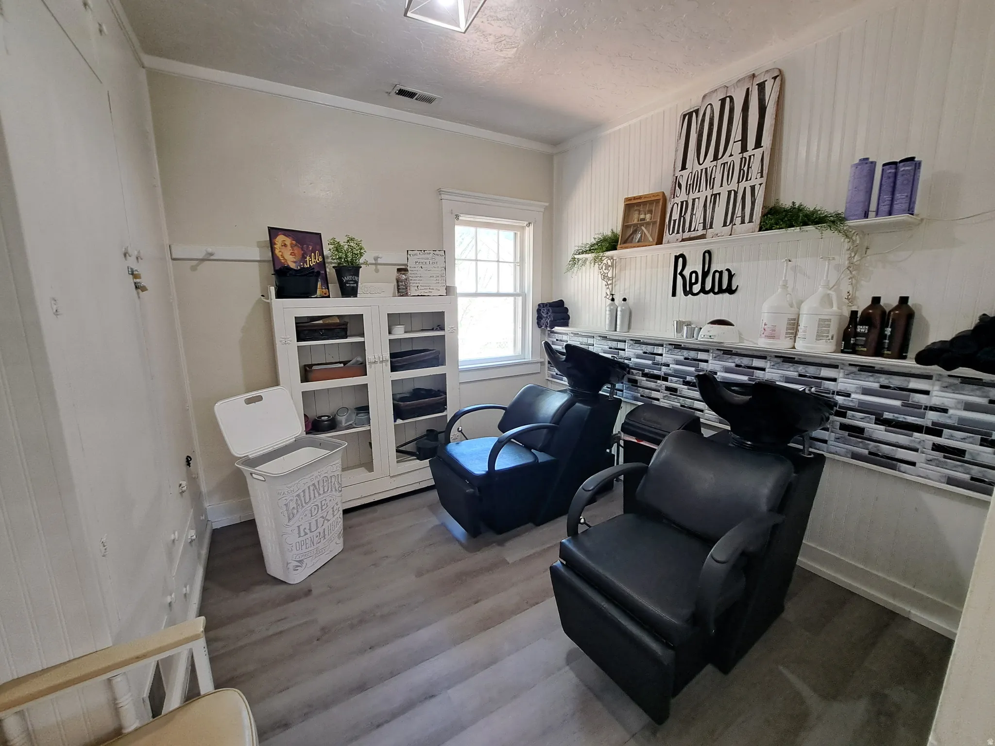 Room with a textured ceiling, crown molding, and wood finished floors