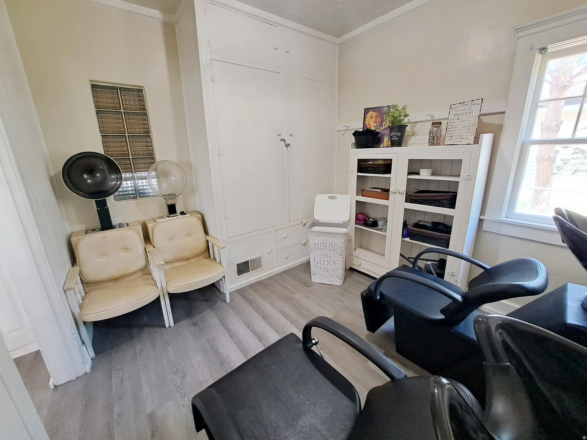 Area with light wood-style floors and ornamental molding