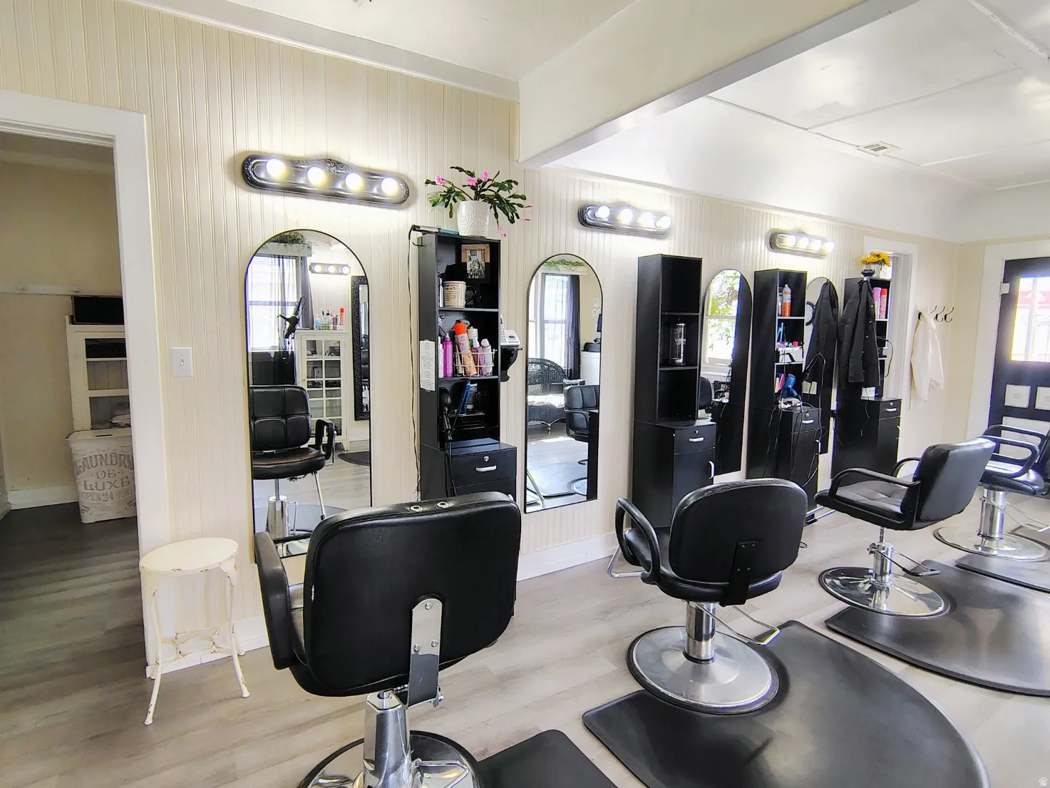 Great Room with light LVP flooring and arched walkways