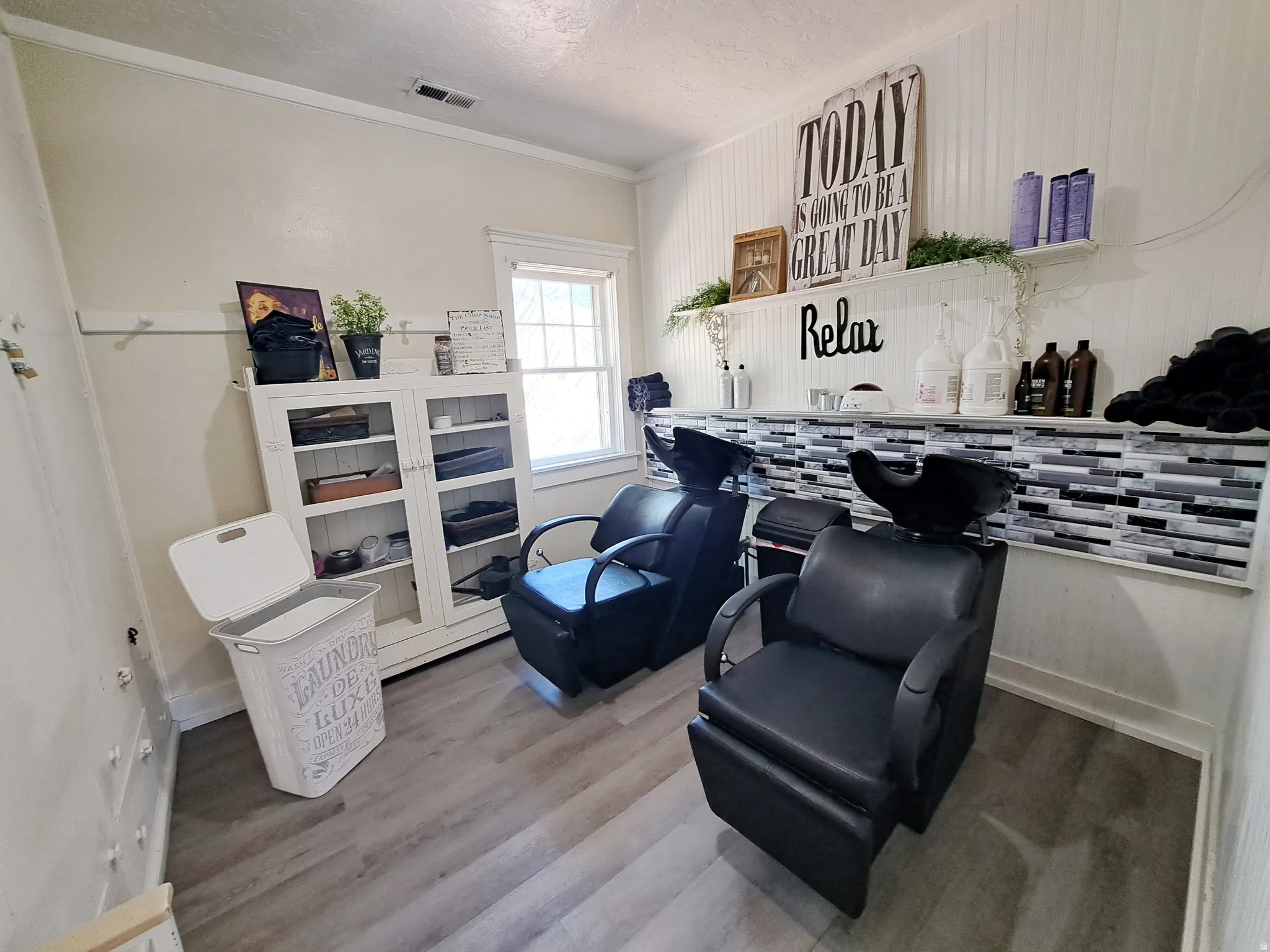 Area featuring light wood-type flooring, ornamental molding, and a textured ceiling