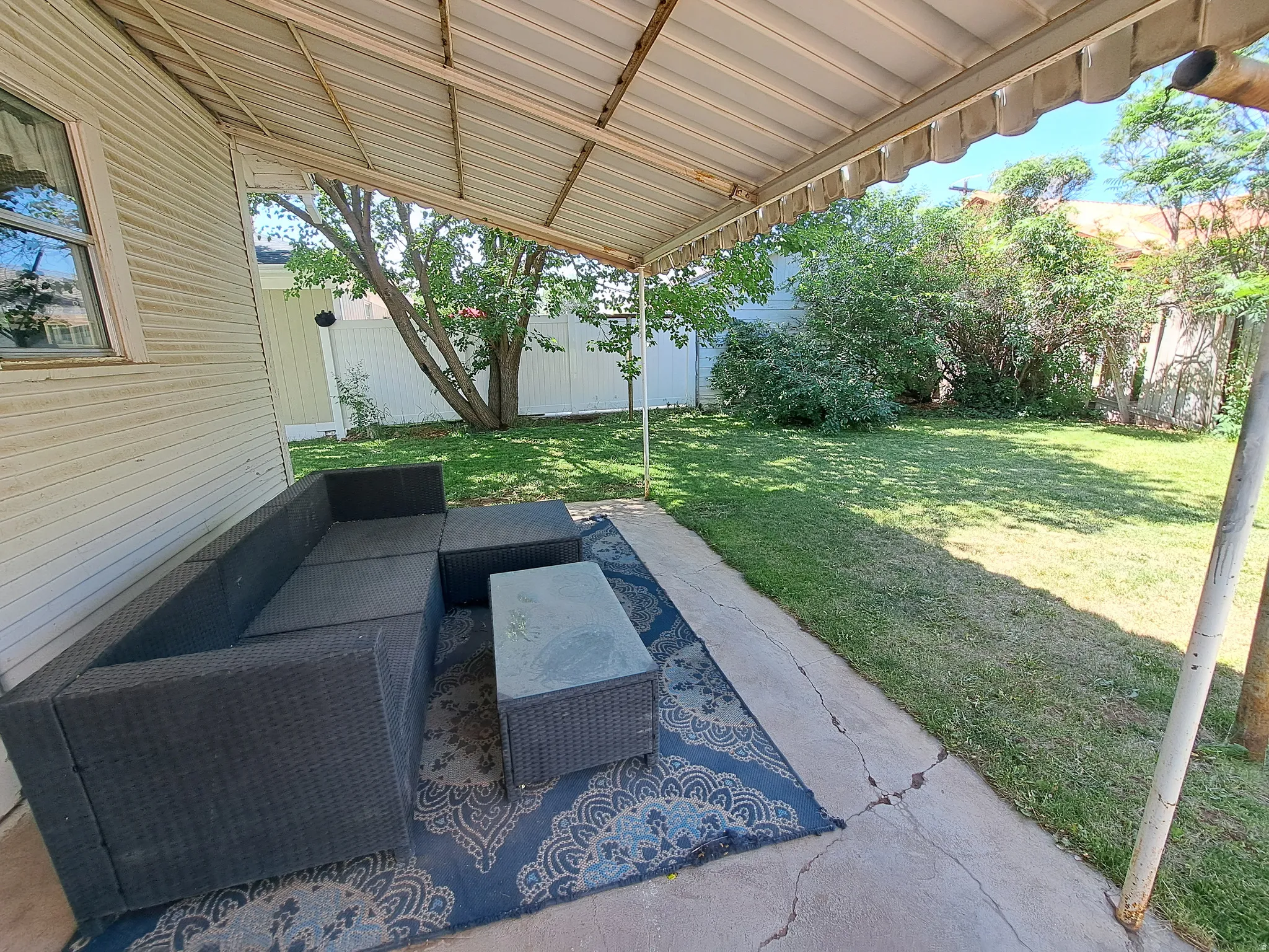 Fenced backyard featuring an outdoor lounge area and a patio